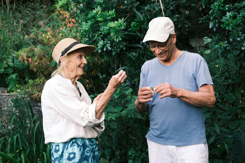 An older couple talking in a green garden